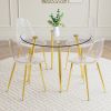 A modern minimalist style round transparent tempered glass table with gold metal legs