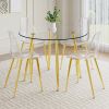 A modern minimalist style round transparent tempered glass table with gold metal legs